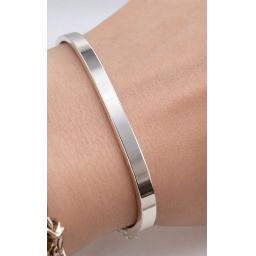 Sterling silver square bangle on wrist with full UK assay hallmarking