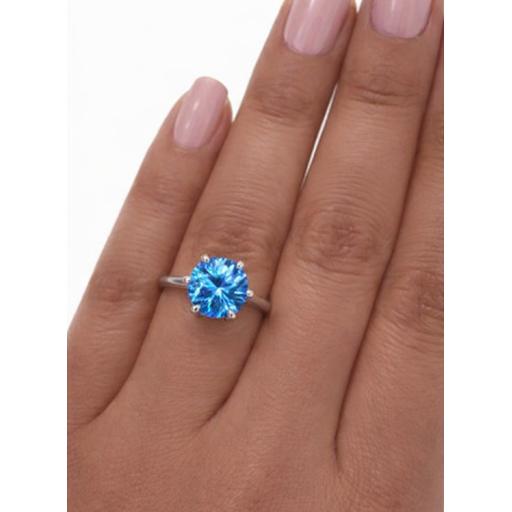 Eastons Sterling silver  2ct sea blue moissanite solitaire on a finger with round brilliant centre stone and side stones